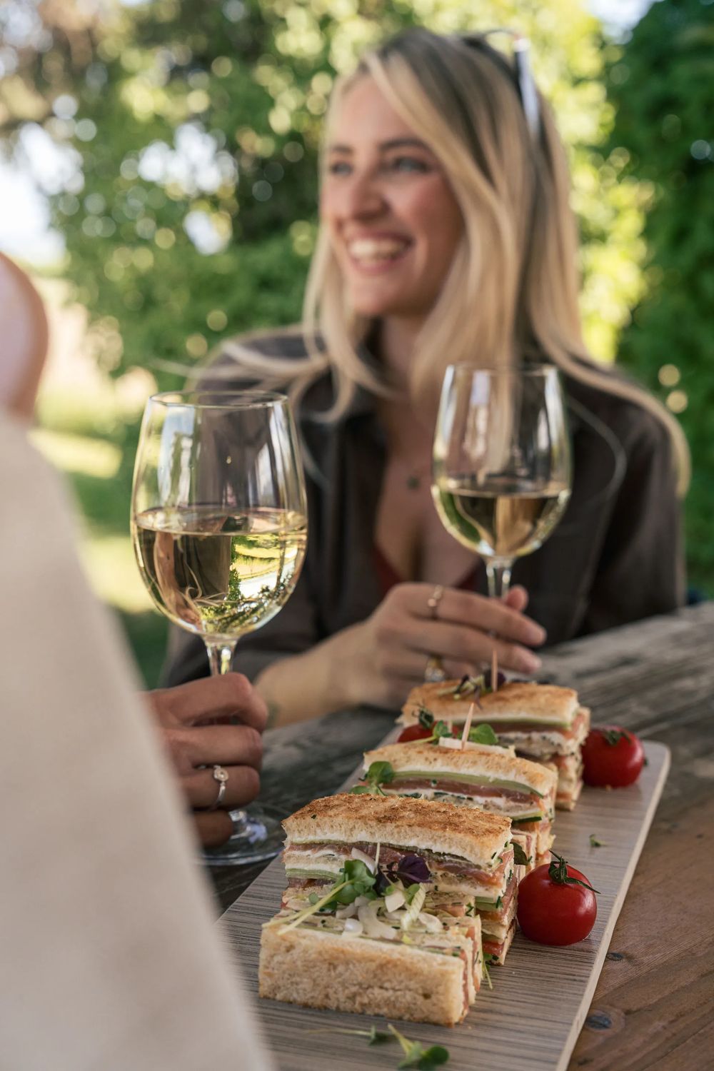 Un verre de vin et un club sandwich au bord de la piscine